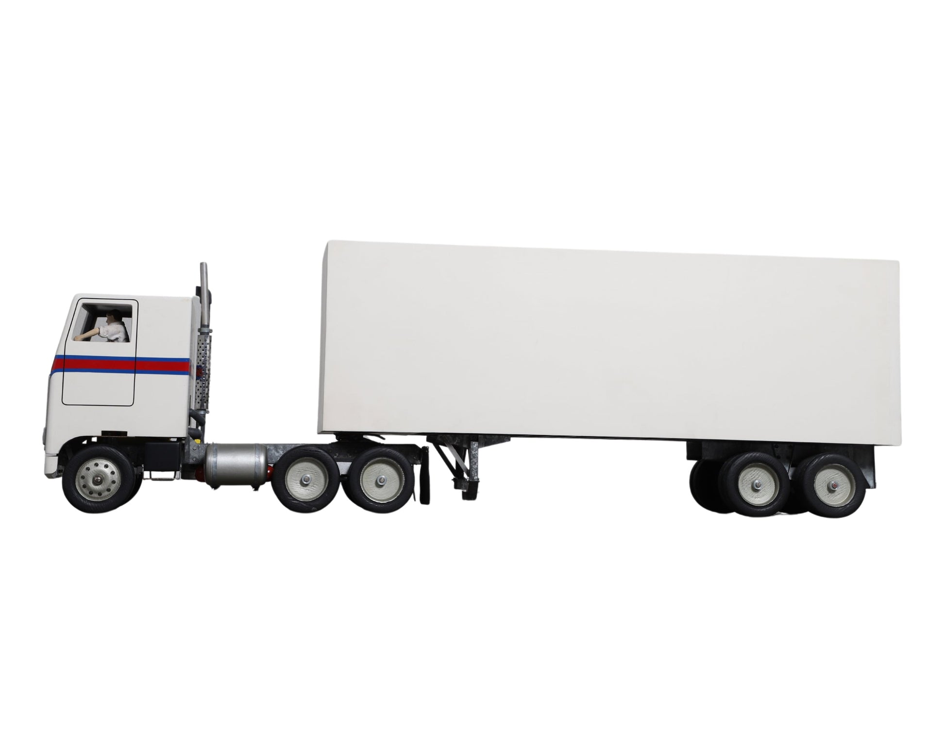  Side view of vintage trailer with attached cab.