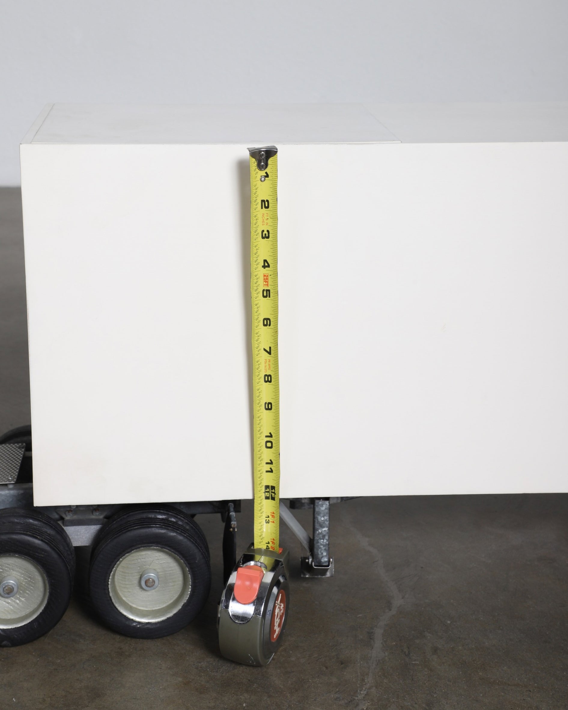 Scale comparison of semi-truck height with tape measure.