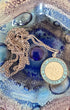 Vintage blue and white enamel St. Christopher pendant on sterling chain - displayed in art glass dish.