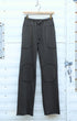 Front-on view of mocha patch pants hanging on a wood hanger.