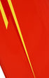 Detail of elongated yellow Lightning Bolt graphic on restored red vintage surfboard.