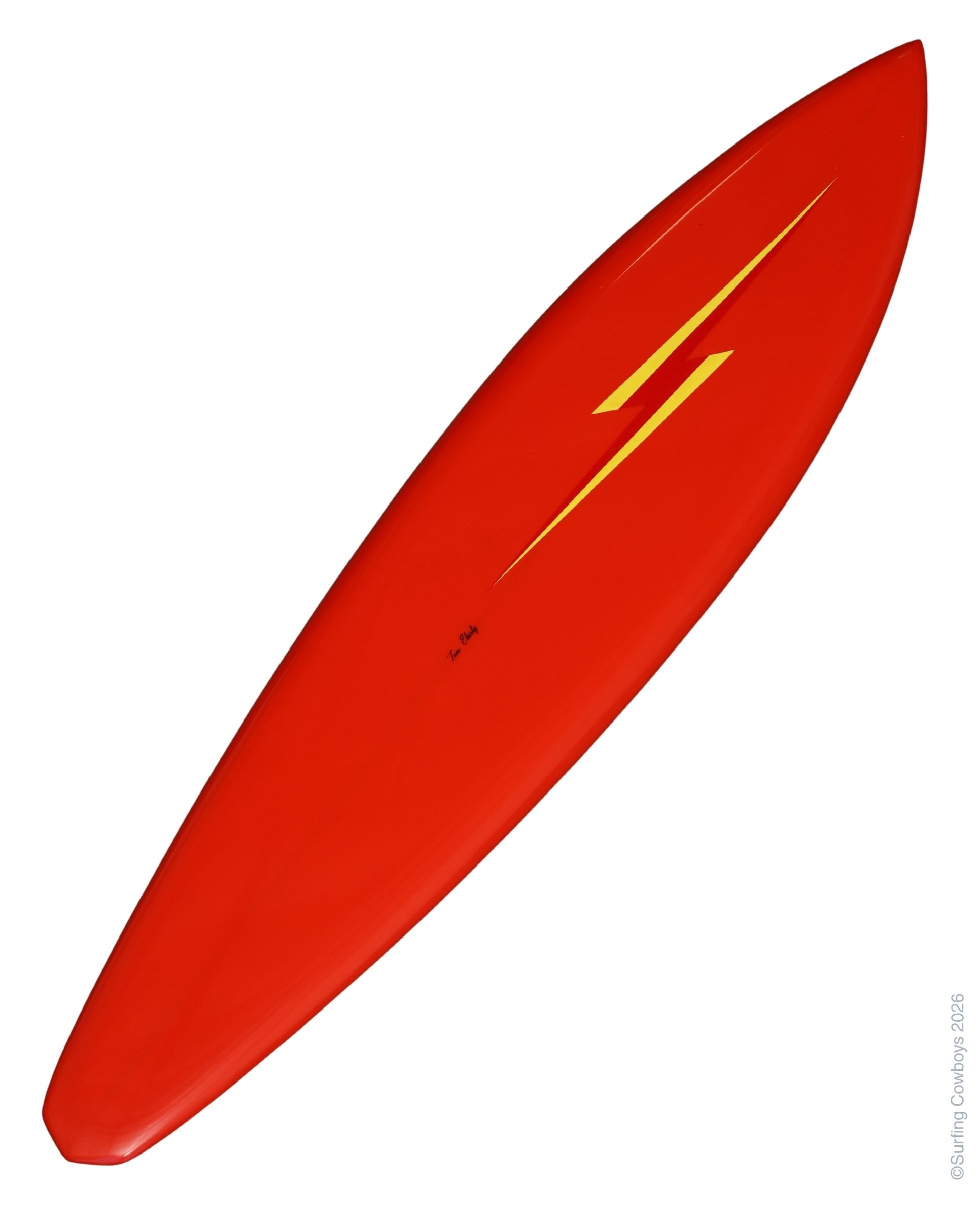 Angled Full-length view of restored red Lightning Bolt surfboard shaped by Tom Eberly.
