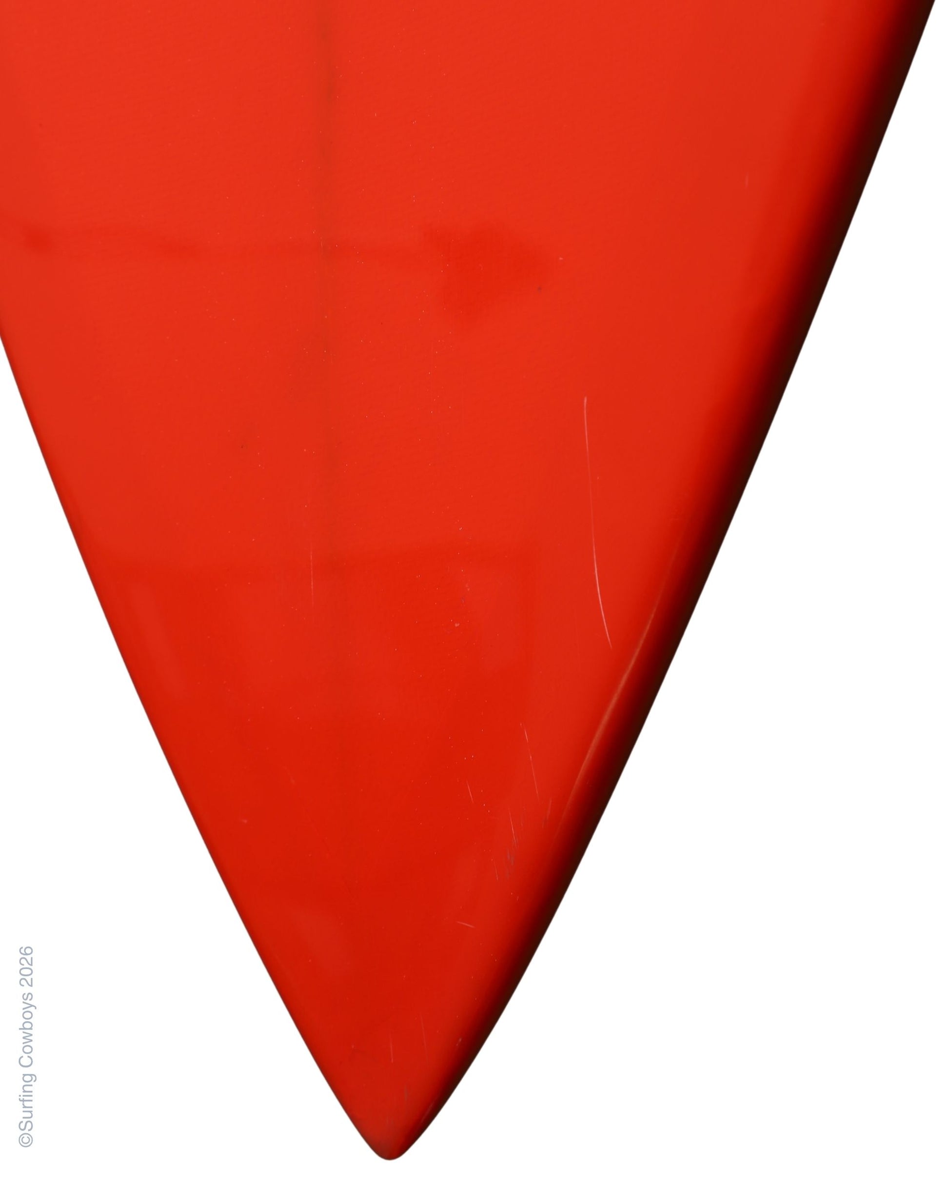 Nose detail on restored red vintage Lightning Bolt surfboard.