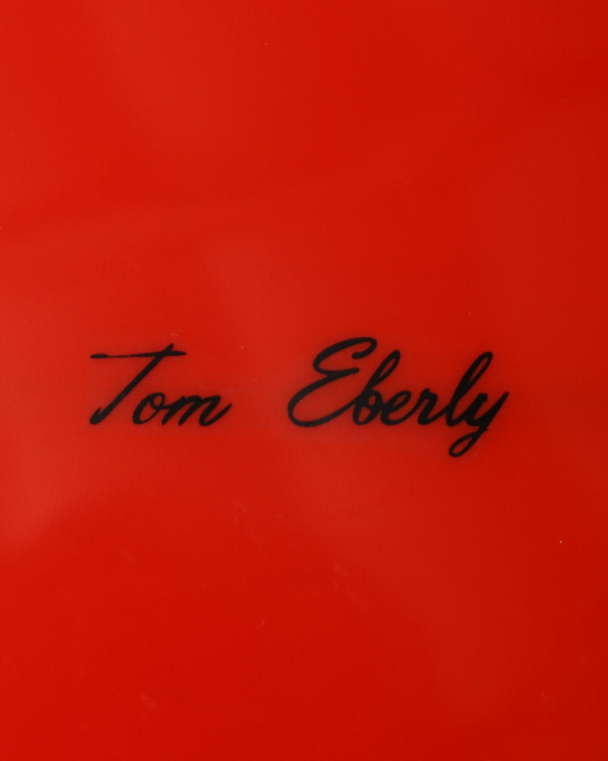 Tom Eberly hand-scripted signature on vintage Lightning Bolt surfboard.