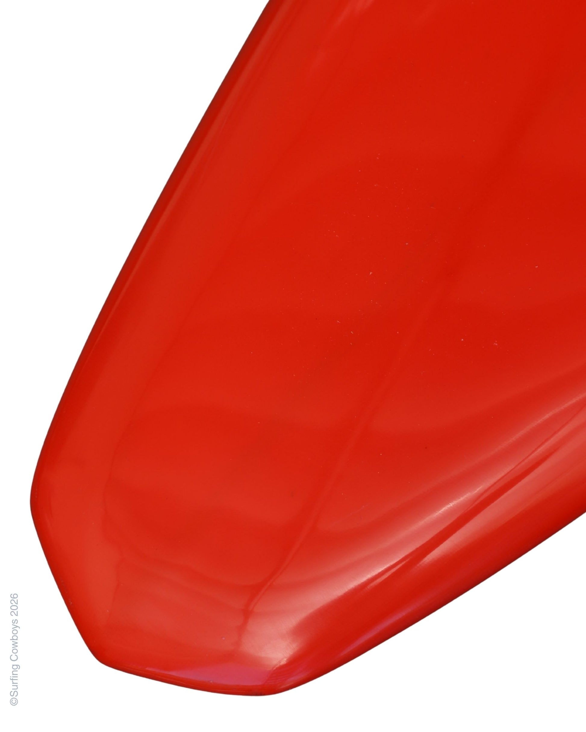 Tail detail on restored red vintage Lightning Bolt single-fin surfboard.
