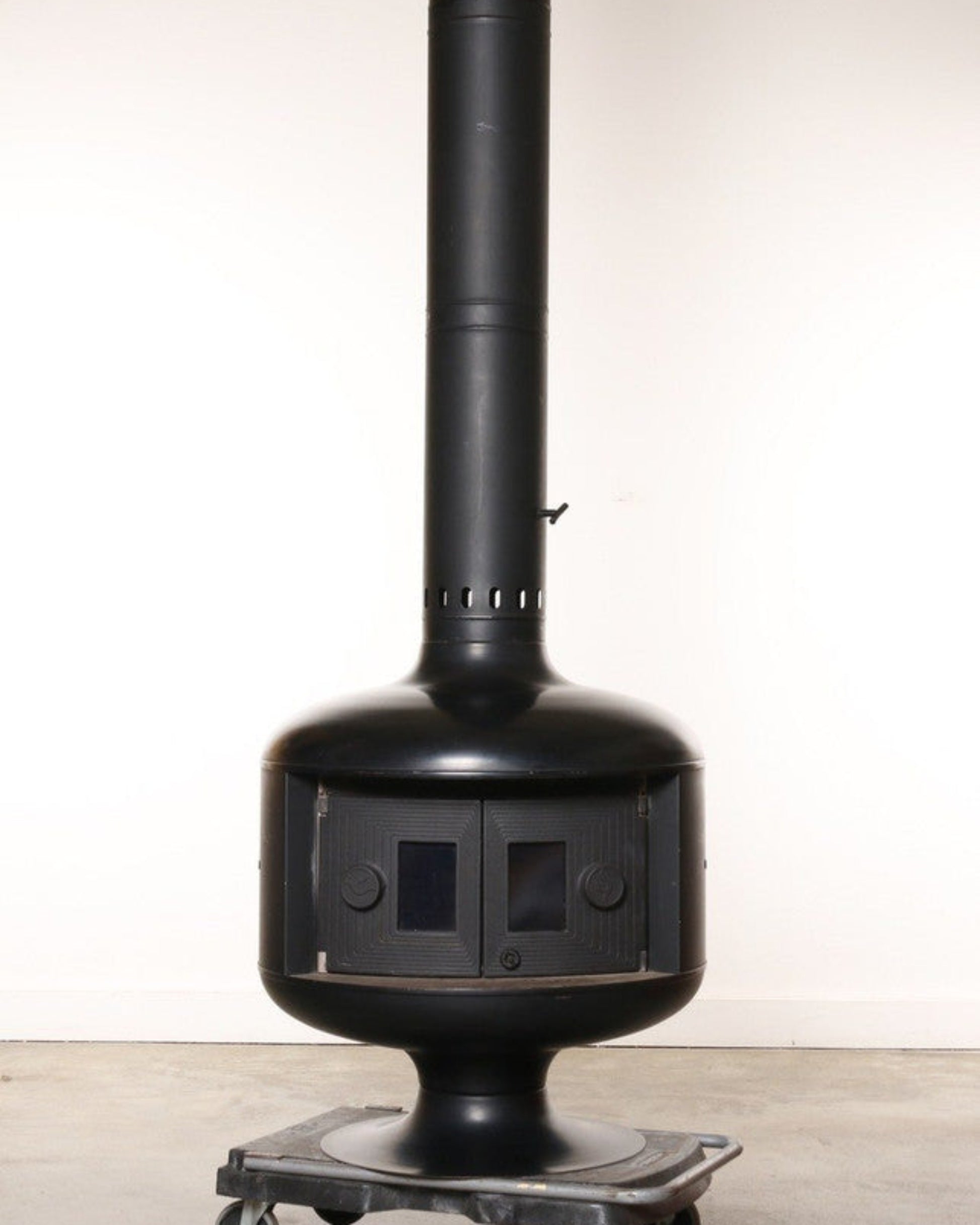 Black metal stove with chimney on a white background