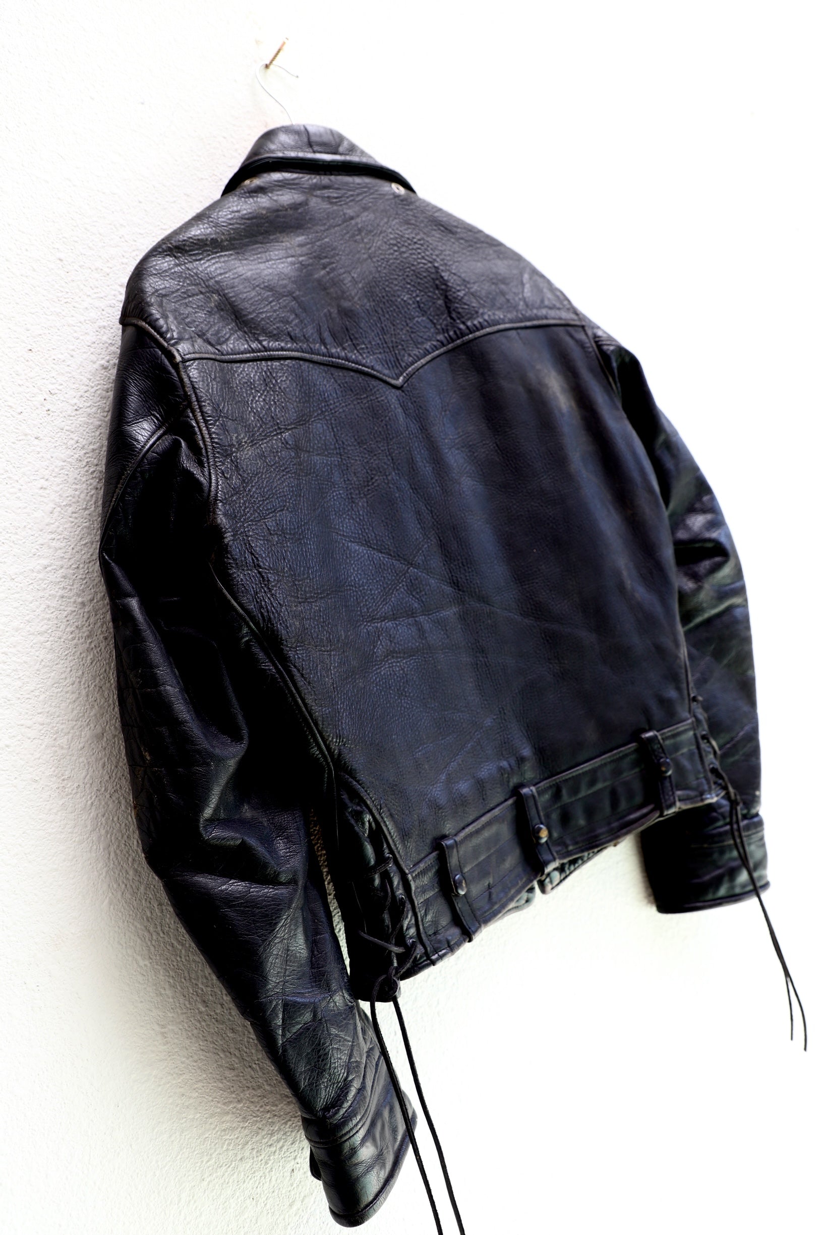 1950s Taubers black horsehide leather jacket with lace-up sides, Western-inspired yoke, and visible signs of wear. details - back side view.