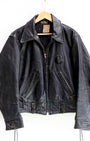 1950s Taubers black horsehide leather jacket with lace-up sides, Western-inspired yoke, and visible signs of wear.