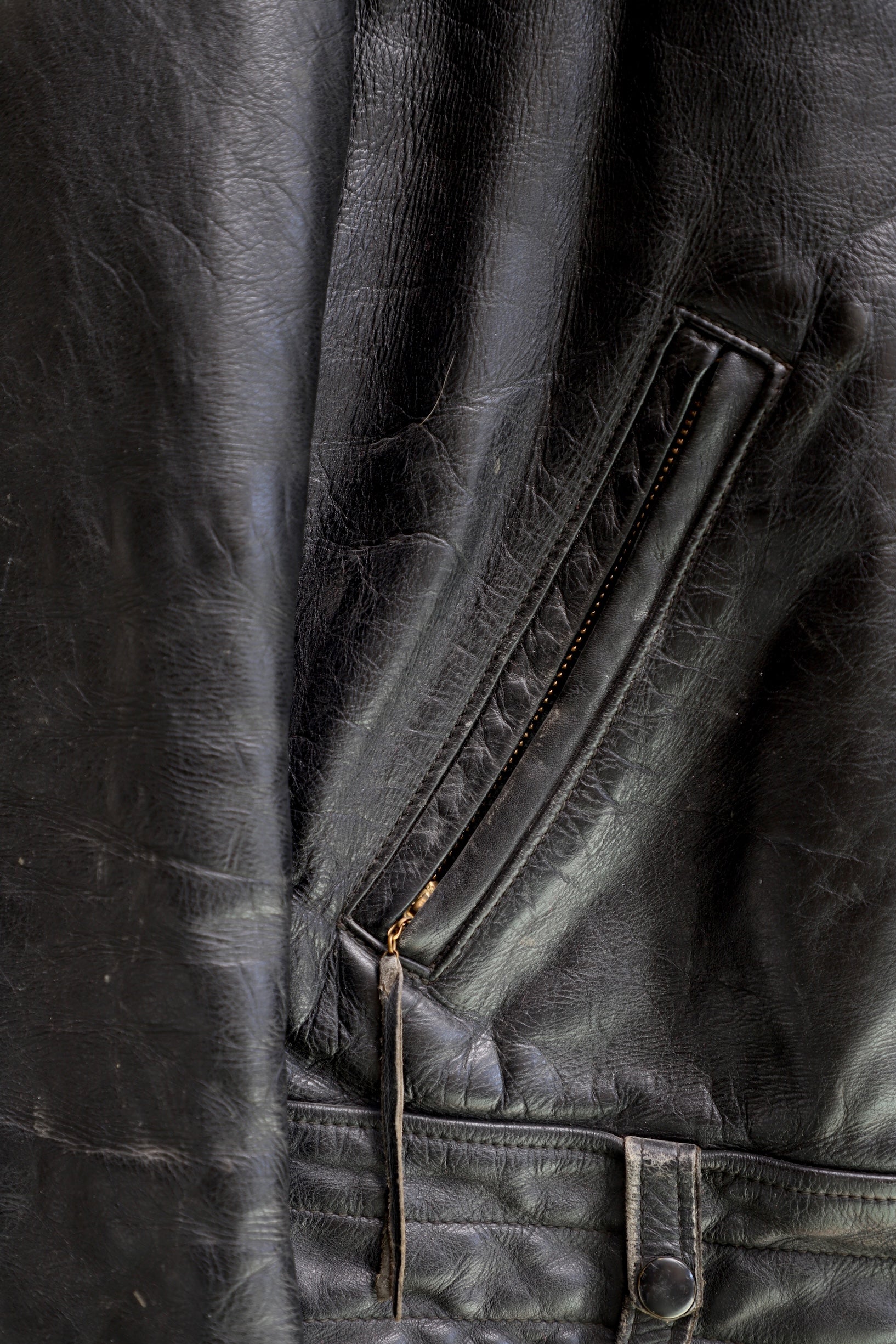 Pocket zip detail 1950s Taubers black horsehide leather jacket with lace-up sides, Western-inspired yoke, and visible signs of wear.
