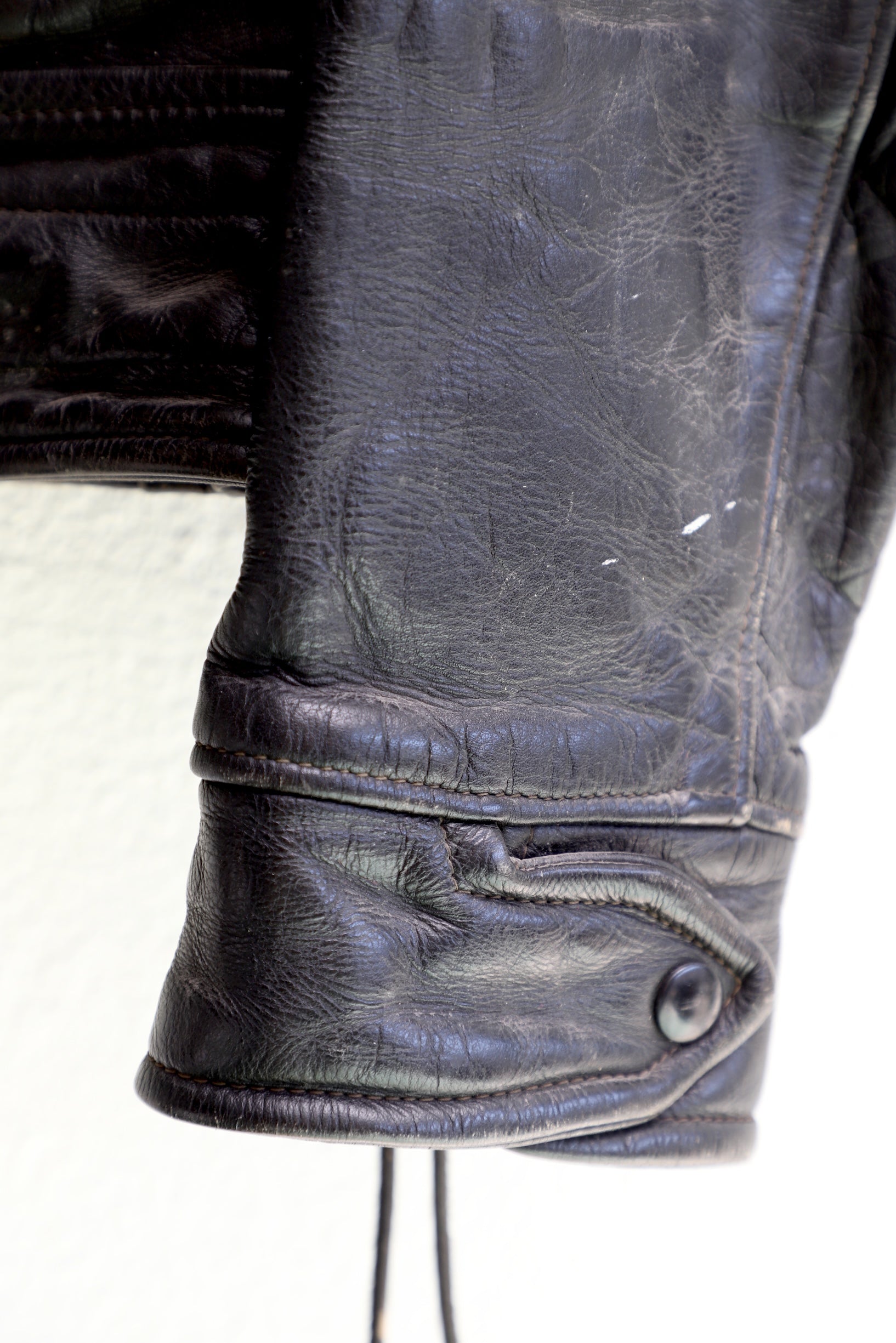 Cuff Detail 1950s Taubers black horsehide leather jacket with lace-up sides, Western-inspired yoke, and visible signs of wear.
