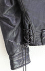 Lace, sleeve and cuff detail 1950s Taubers black horsehide leather jacket with lace-up sides, Western-inspired yoke, and visible signs of wear.
