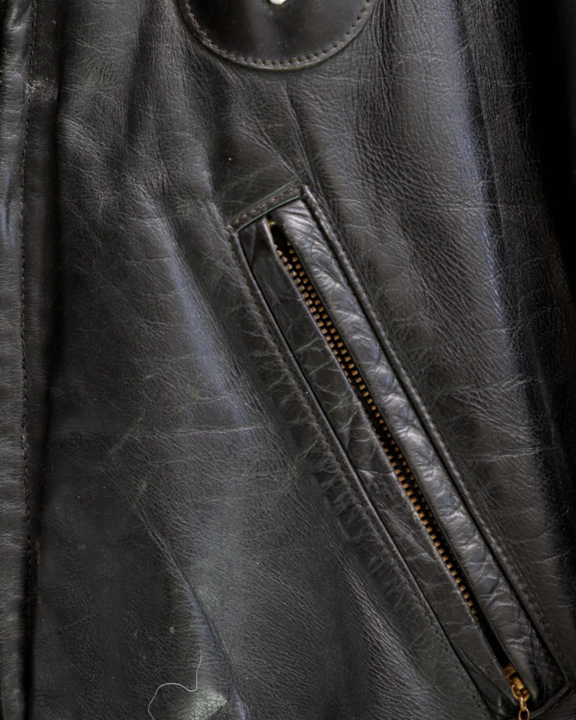 Pocket detail: 1950s Taubers black horsehide leather jacket with lace-up sides, Western-inspired yoke, and visible signs of wear.