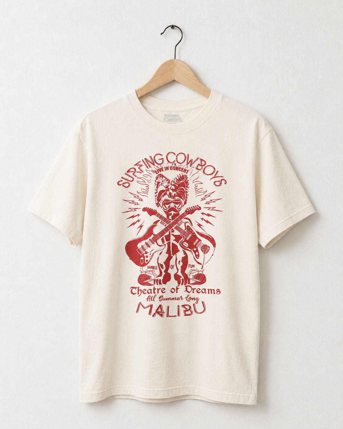 Cream Surfing Cowboys Tiki-Rock Malibu T-shirt with bold red tiki figure and vintage-style guitar graphic.