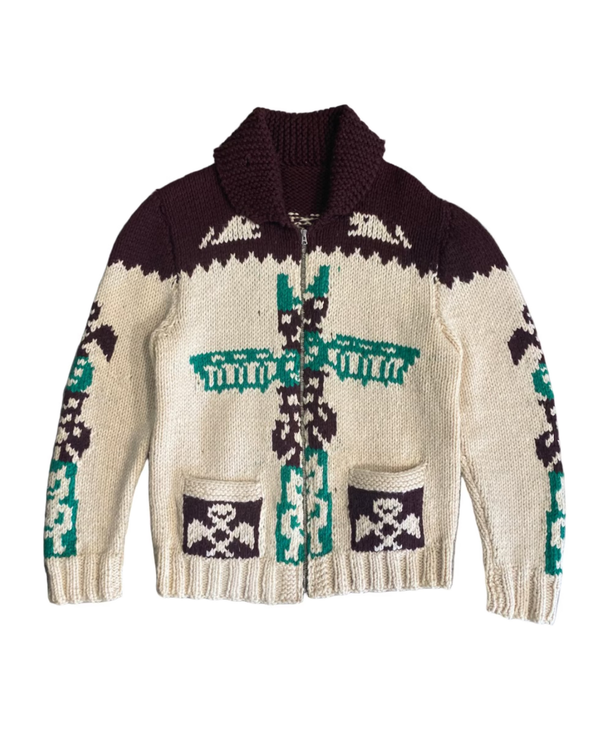 Front view of 1970s beige wool cardigan with green and brown totem pole design.
