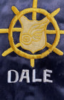 Detail of yellow wheel and wing military emblem with DALE name.