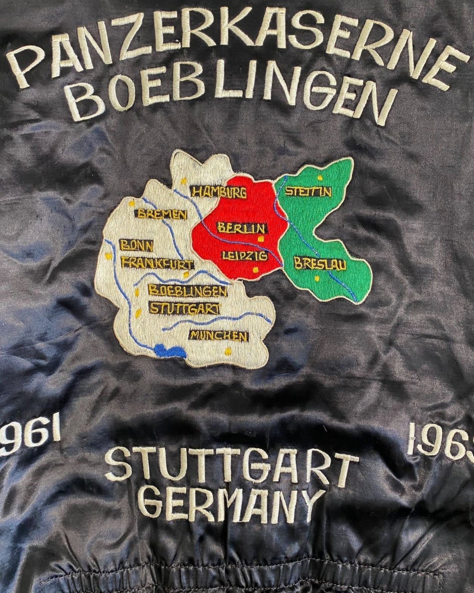 Close-up of Panzerkaserne Boeblingen embroidery with labeled German cities.