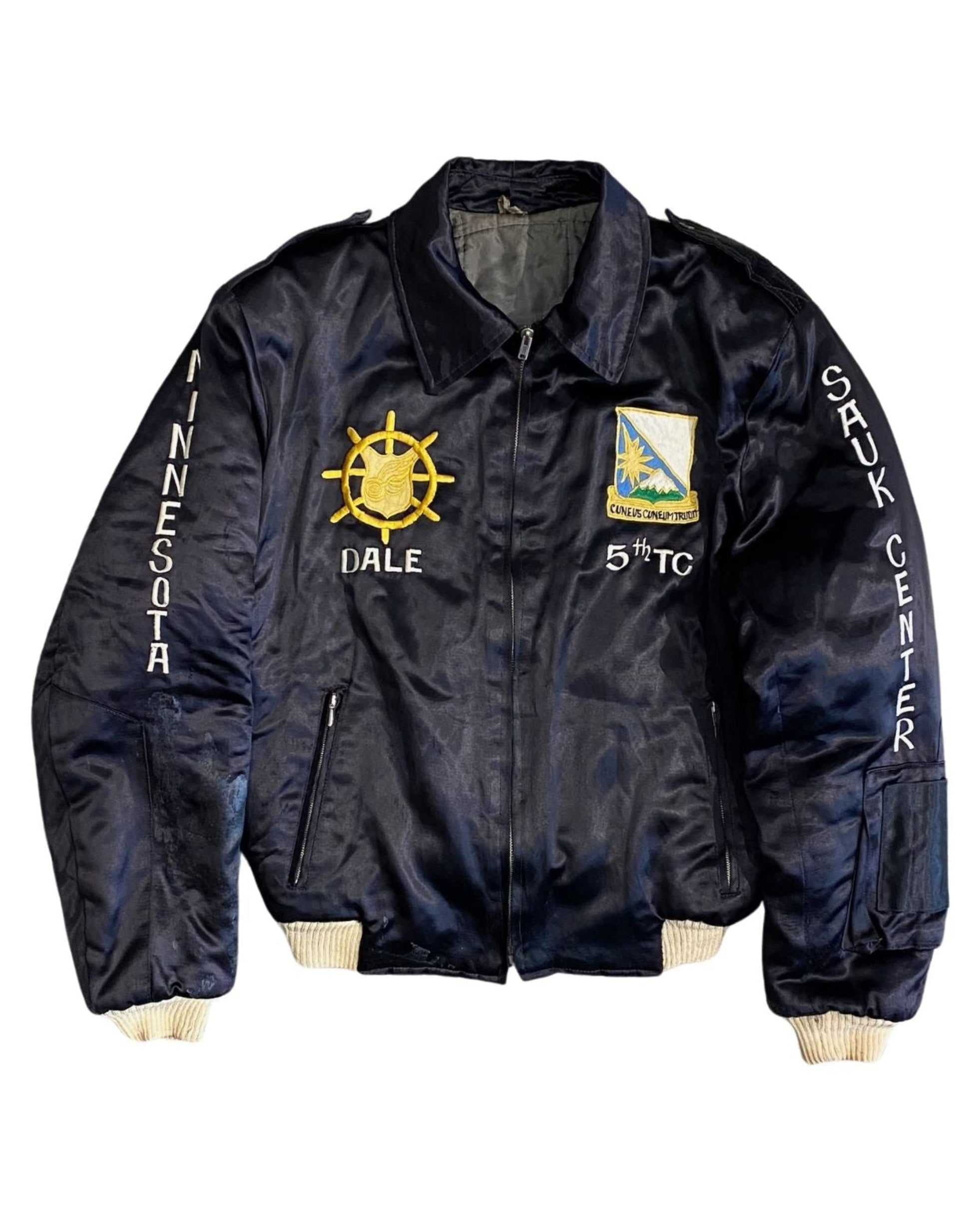 Front of vintage 1962 US Army tour jacket with embroidered insignia and patches.