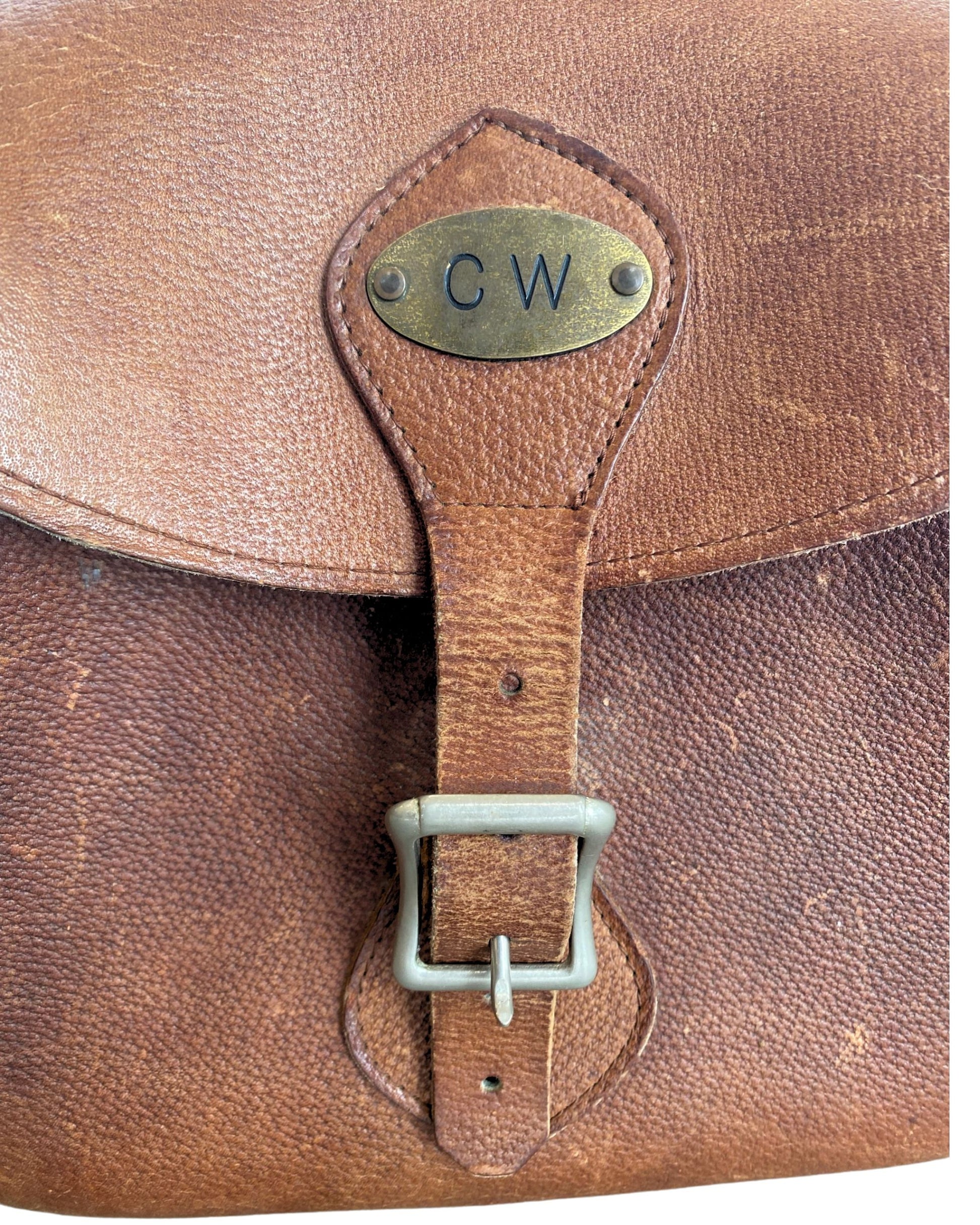 Close-up of brass CW monogram plate and buckle.