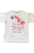 Back of vintage 1987 Vietnam Veterans Welcome Home concert T-shirt featuring patriotic graphics and musician lineup.