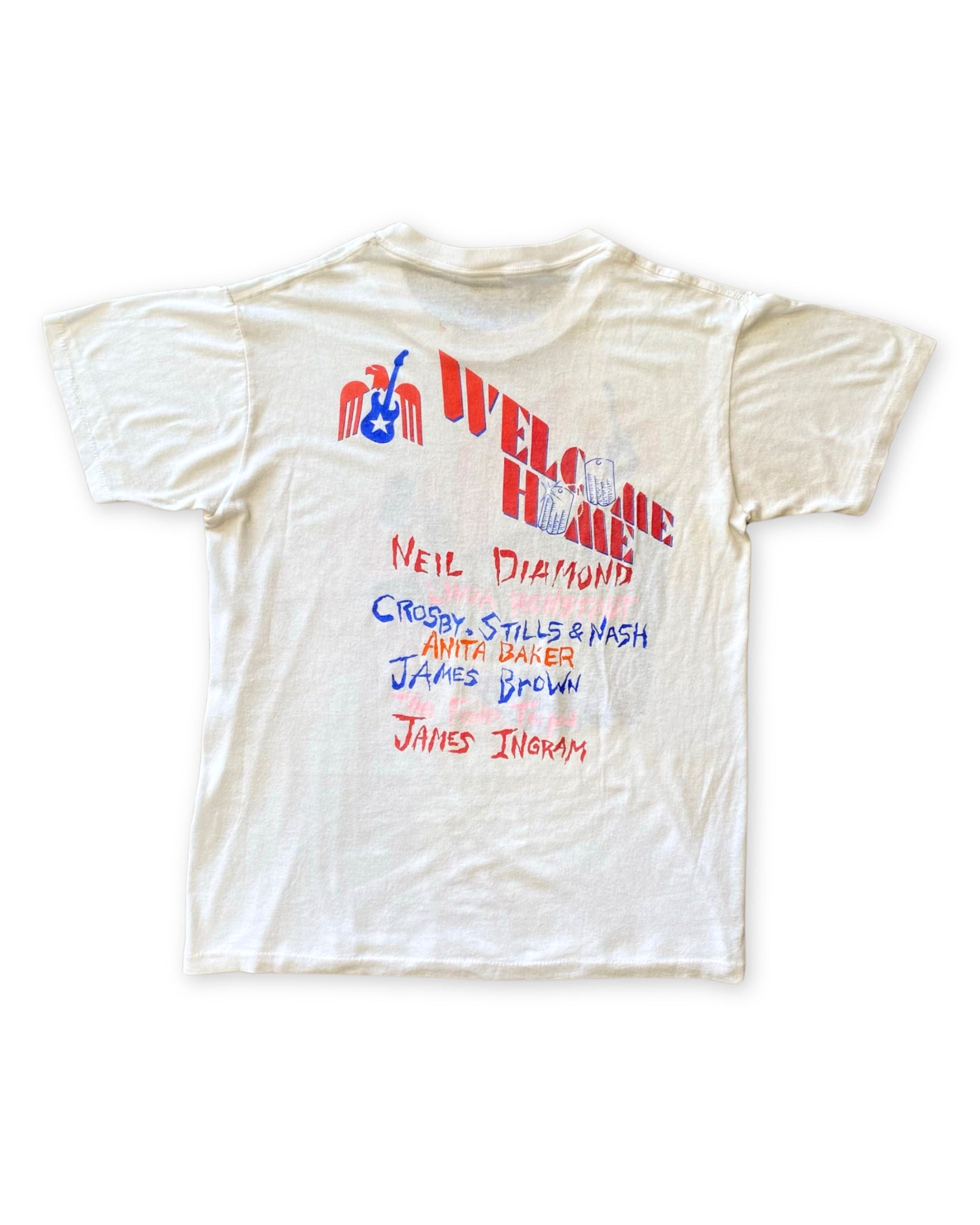 Back of vintage 1987 Vietnam Veterans Welcome Home concert T-shirt featuring patriotic graphics and musician lineup.