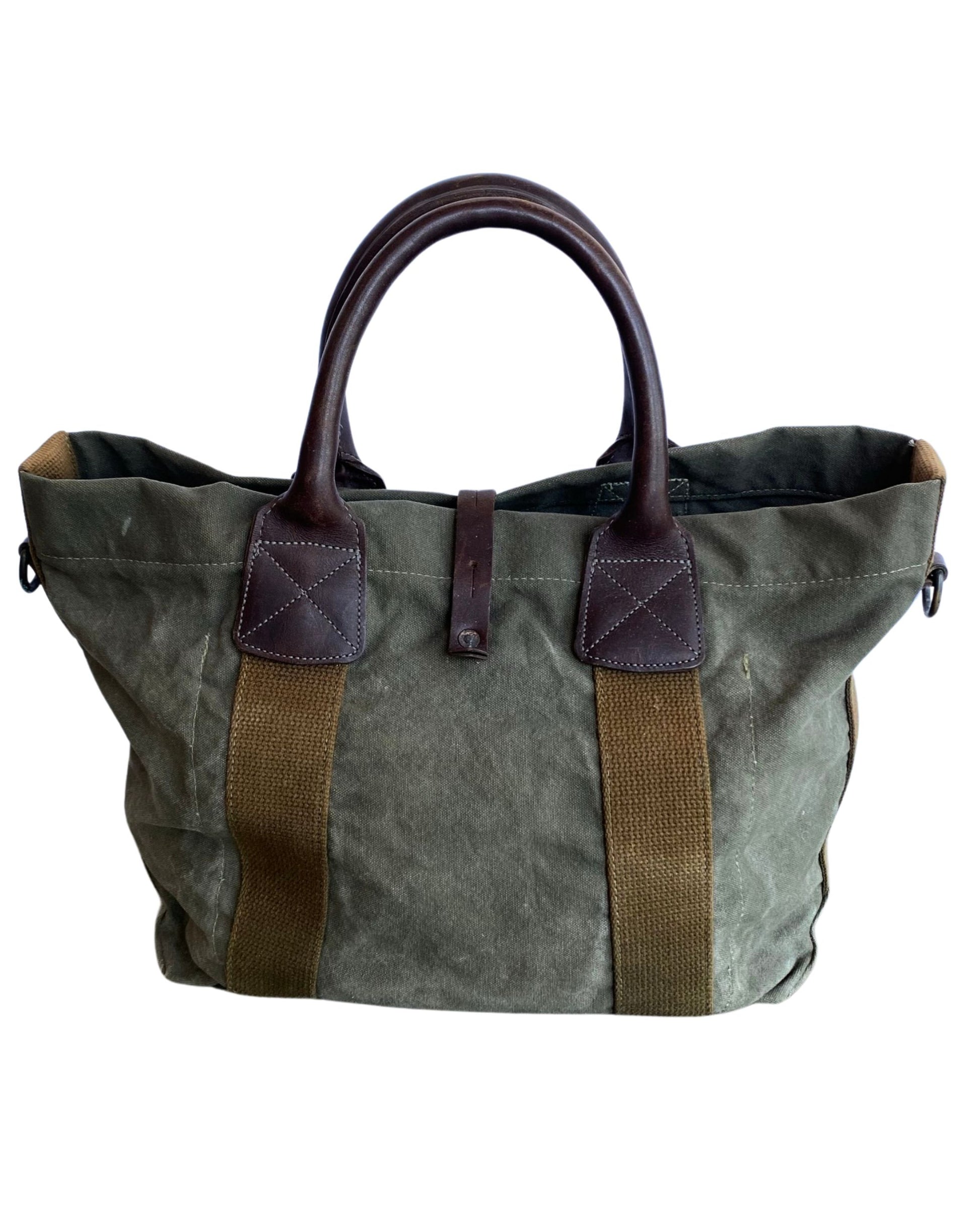 Vintage olive green canvas military tote with brown leather handles and webbing straps, interior zip pocket shown. Back.