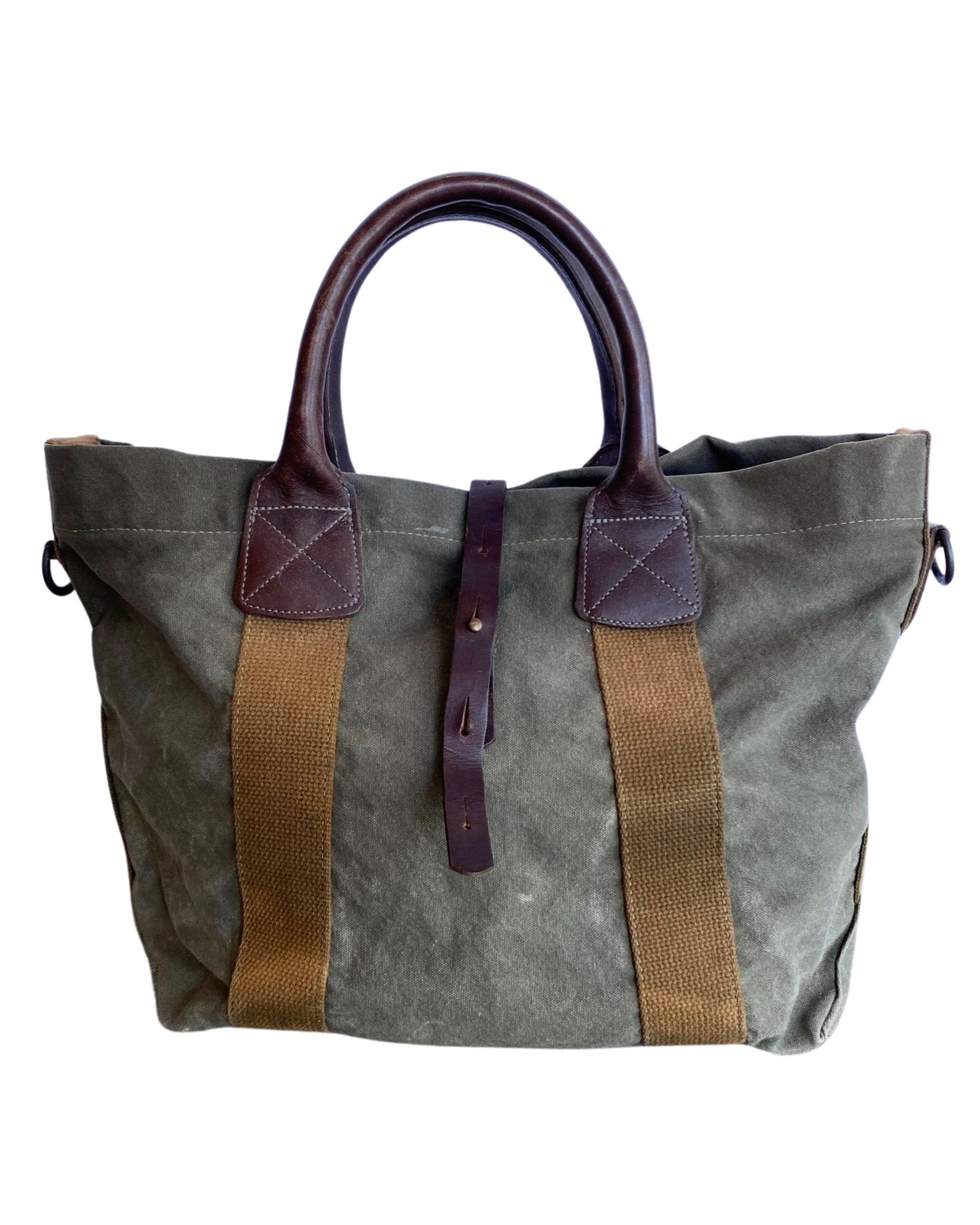Vintage olive green canvas military tote with brown leather handles and webbing straps, interior zip pocket shown. Front.