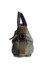 Vintage olive green canvas military tote with brown leather handles and webbing straps, interior zip pocket shown. Side.