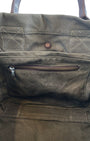 Vintage olive green canvas military tote with brown leather handles and webbing straps, interior zip pocket shown. Inside Detail.