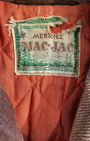 Close-up of plaid pattern and button detail on vintage Mac-Jac coat.
Interior lining of 1960s Mac-Jac brown wool blend coat.