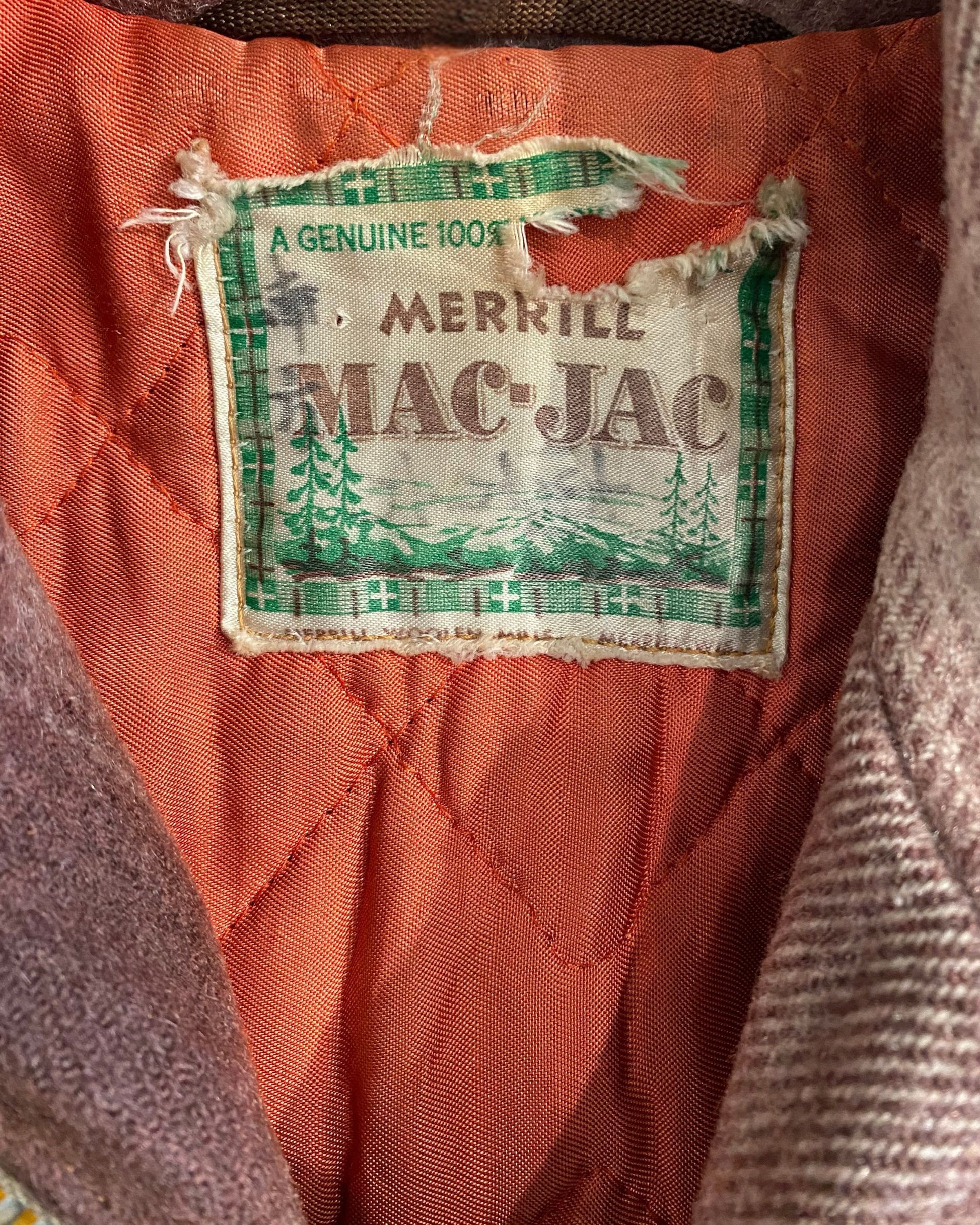 Close-up of plaid pattern and button detail on vintage Mac-Jac coat.
Interior lining of 1960s Mac-Jac brown wool blend coat.