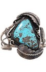 Vintage Navajo Sterling Silver Cuff with Triangular Turquoise Stone on white background.