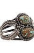 Side angle showing leaf motif and twin turquoise stones.