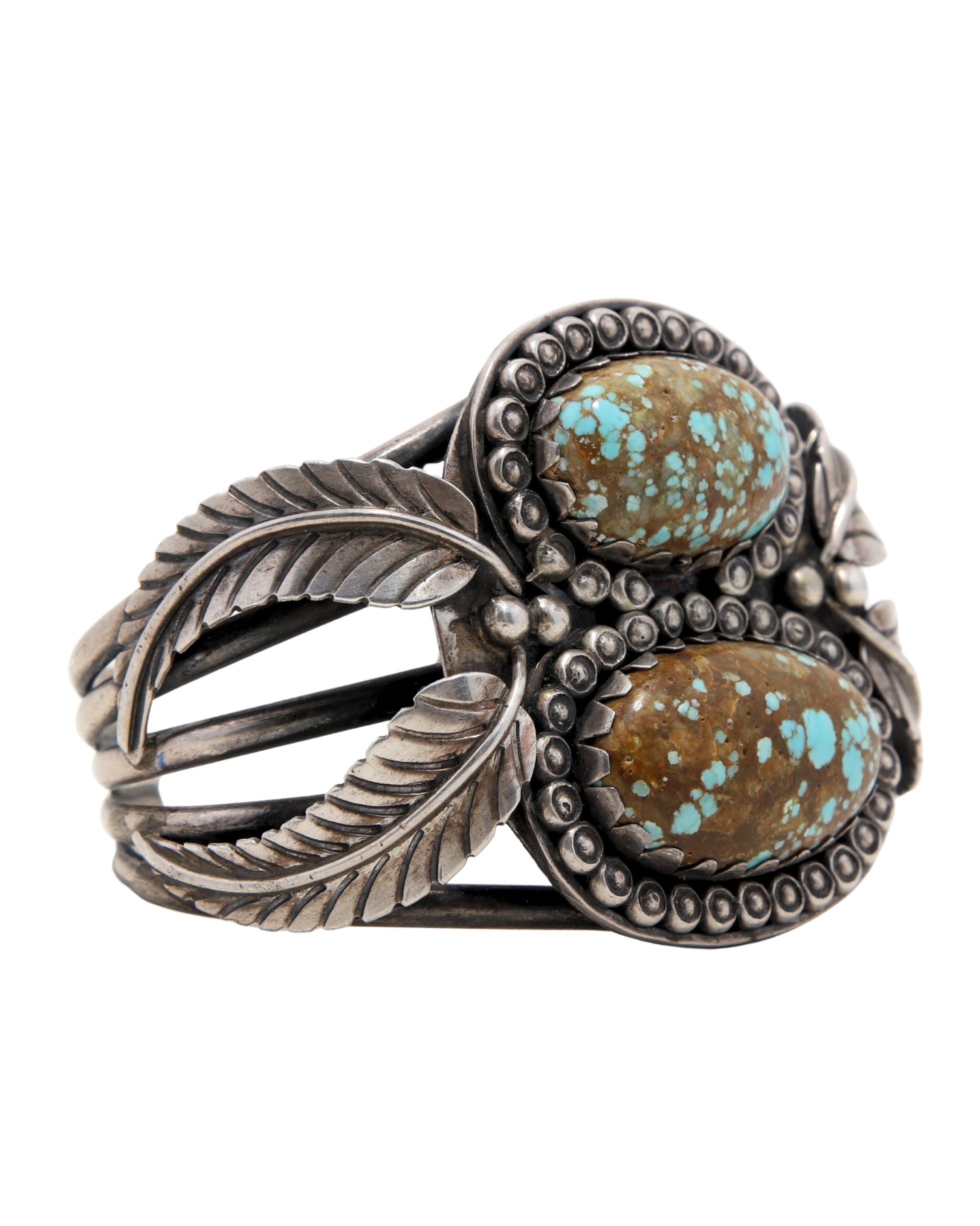 Side angle showing leaf motif and twin turquoise stones.