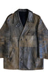 Front view of vintage 1940s Noël Cuir double-breasted leather coat with natural black-to-tobacco patina, shown flat on concrete floor.