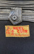 Close-up of original Noël Cuir Marque Déposée label, 46 Rue Pixérécourt Paris 20e, with leather interior button tab detail.