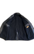 Full interior view of vintage Noël Cuir leather coat showing heavy black wool lining and original label on interior pocket.