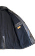 Detail of interior left panel showing leather belt tab construction and black wool lining of vintage Noël Cuir coat.
