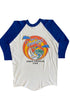 Back view of 1982 Beach Boys North American Tour raglan tee showing full circular sunset graphic with sailboat and palm tree, on white background.