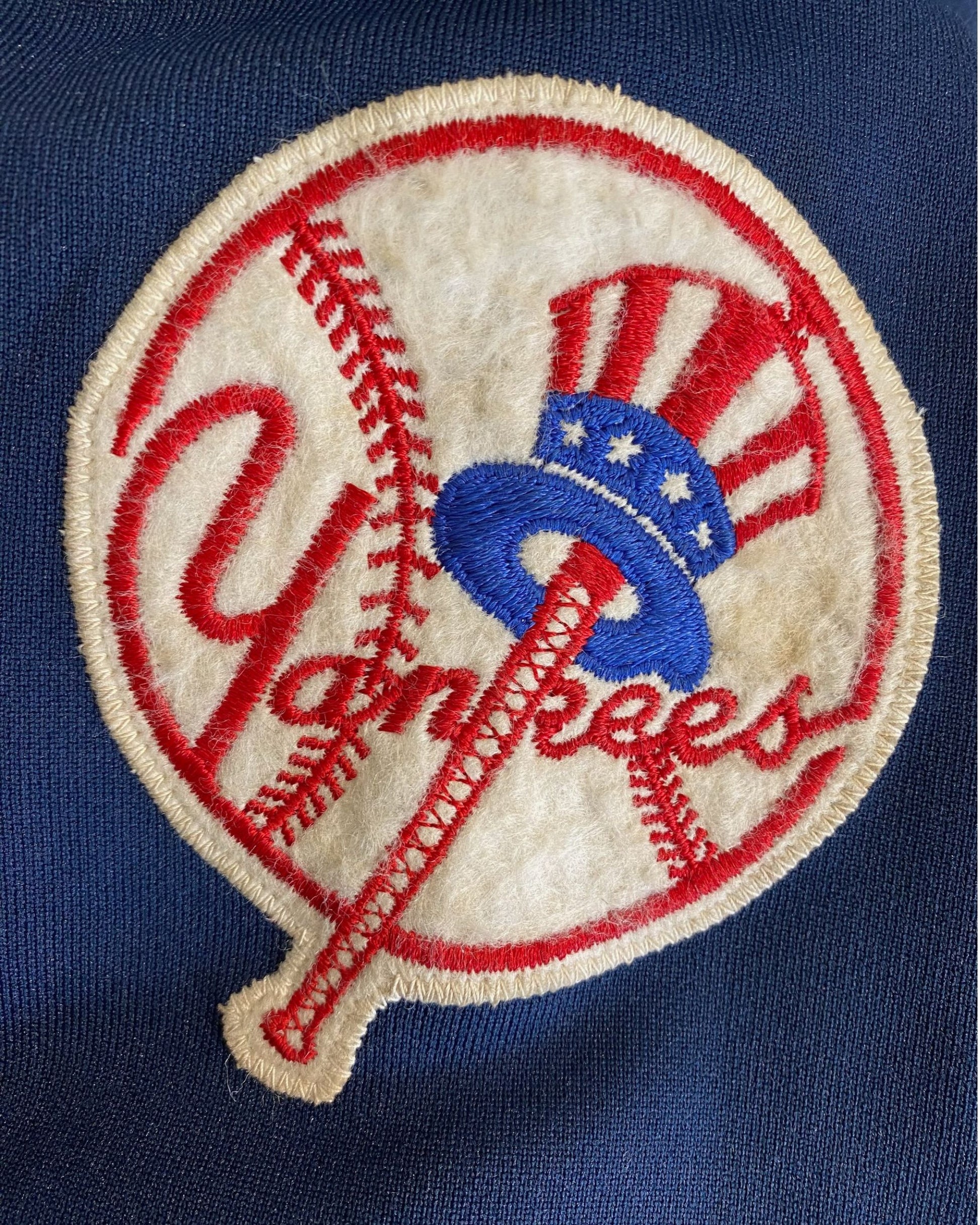 Felt and embroidered Yankees baseball patch on sleeve.