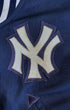 Detail of embroidered Yankees chest logo on varsity jacket.