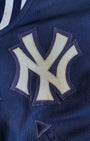 Detail of embroidered Yankees chest logo on varsity jacket.