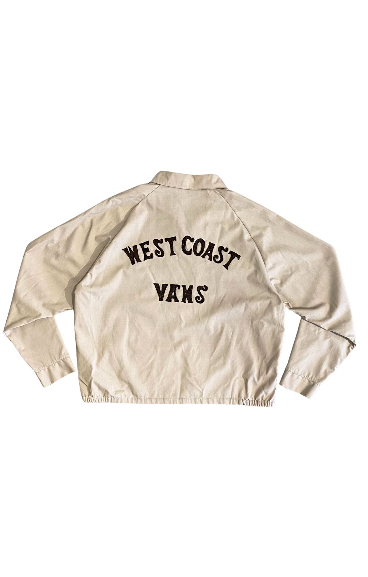 Back view of vintage jacket with black chainstitched “West Coast Vans” lettering.