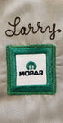 Close-up of green Mopar patch with chainstitched name “Larry” above.