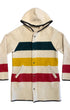 Front view of a cream Woolrich Woman hooded wool coat with green, yellow, and red stripes, snap closures, and angled pockets.