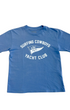 Front of a washed blue toddler T-shirt with a white Surfing Cowboys Yacht Club flag graphic.