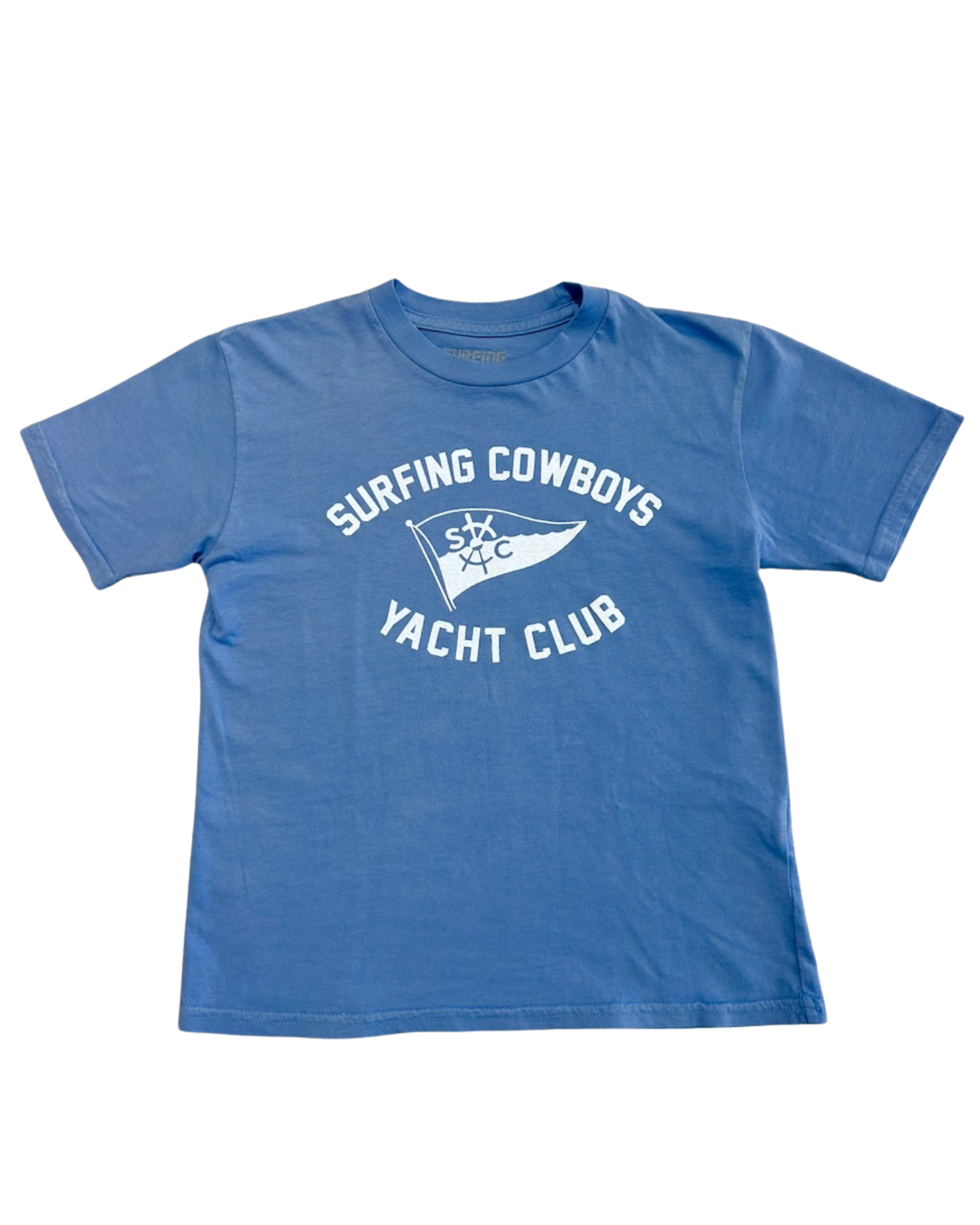 Front of a washed blue toddler T-shirt with a white Surfing Cowboys Yacht Club flag graphic.