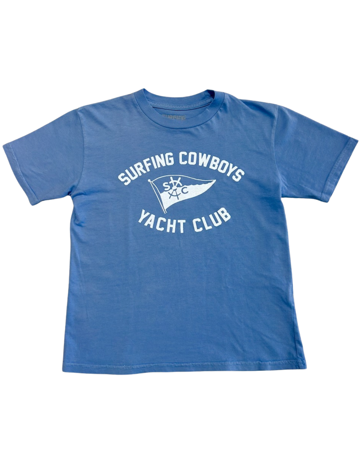Front of a washed blue youth T-shirt with a white Surfing Cowboys Yacht Club flag graphic.