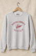 Gray sweatshirt with red text and logo on a beige background