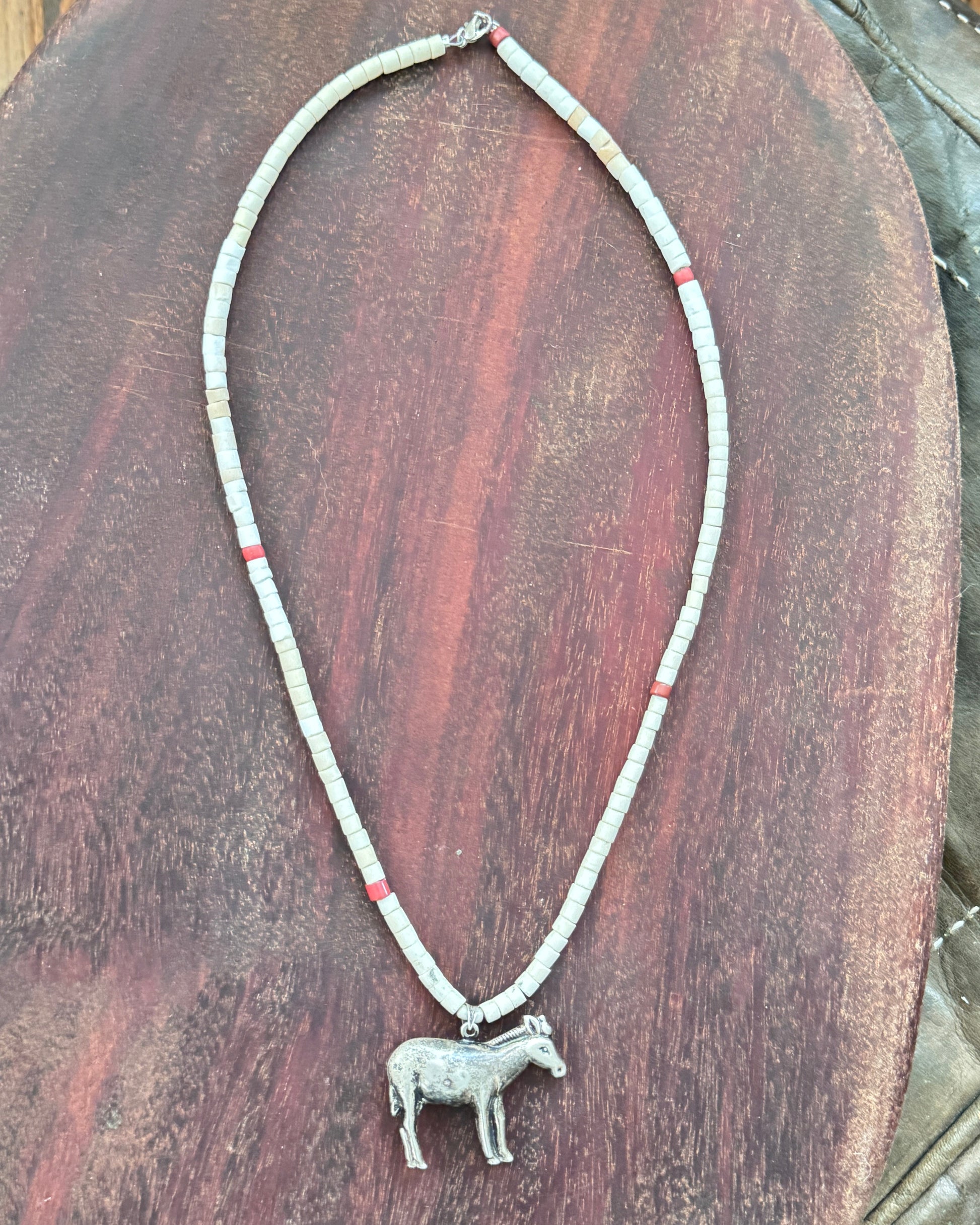 Hollow sterling silver burro pendant on vintage Southwestern bead necklace.