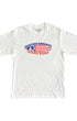 Youth-size white T-shirt with Surfing Cowboys red, white, and blue peace flag surfboard graphic on front.